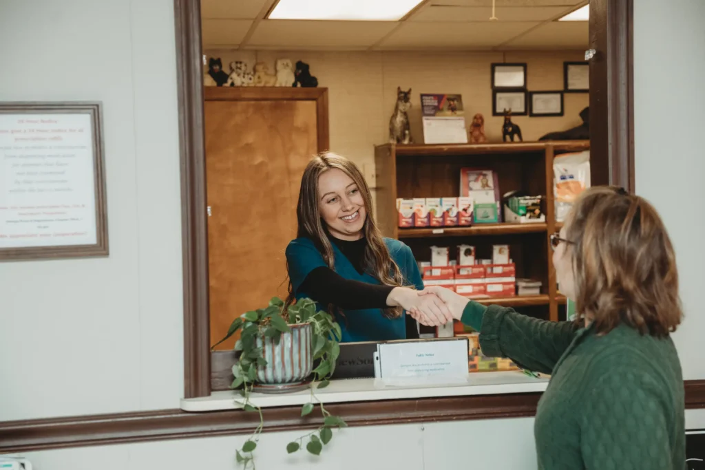 Veterinary staff member shaking hands with a client